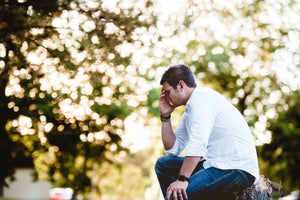 man in nature struggling to hear 