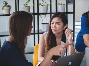 woman struggling to hear in work conversation