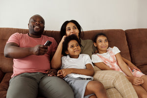 family watching tv with tv listening device 