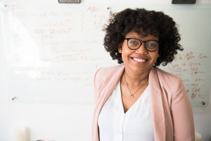 woman in blazer smiling at camera