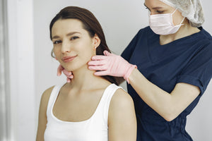 woman having a checkup at doctors for clogged ears 