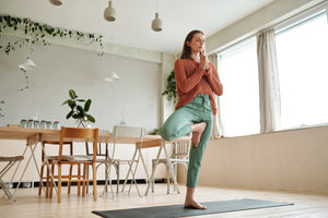 Woman balancing on one leg yoga 