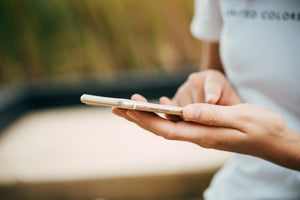 woman's hands using an iphone for hearing loss