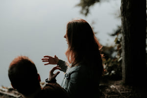 Woman in conversation with one ear to speaker