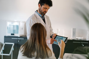 hearing professional with patient showing results 